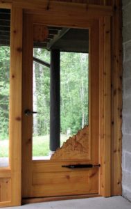 hand carved cedar screen door, hand carved wolf howling,  built by john huisman, ely, mn