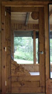 hand carved cedar screen door, hand carved wolf howling,  built by john huisman, ely, mn