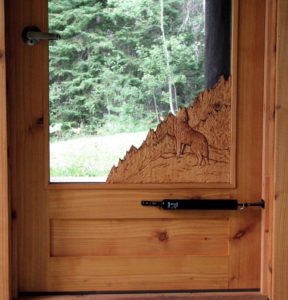 cedar screen door, hand carved wolf howling,  built by john huisman, ely, mn