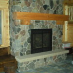 Basement ston fireplace, cedar timber mantel