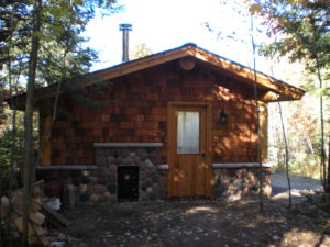 Stone and cedar Sauna building