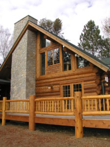 Exterior stone chimney, cedar log home