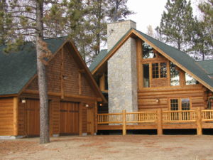 Cedar log home, exterior stone chimney