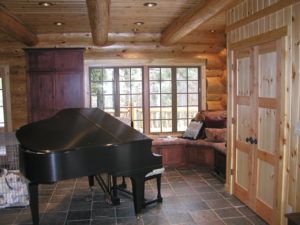 Piano room, cedar log home, lots of glass