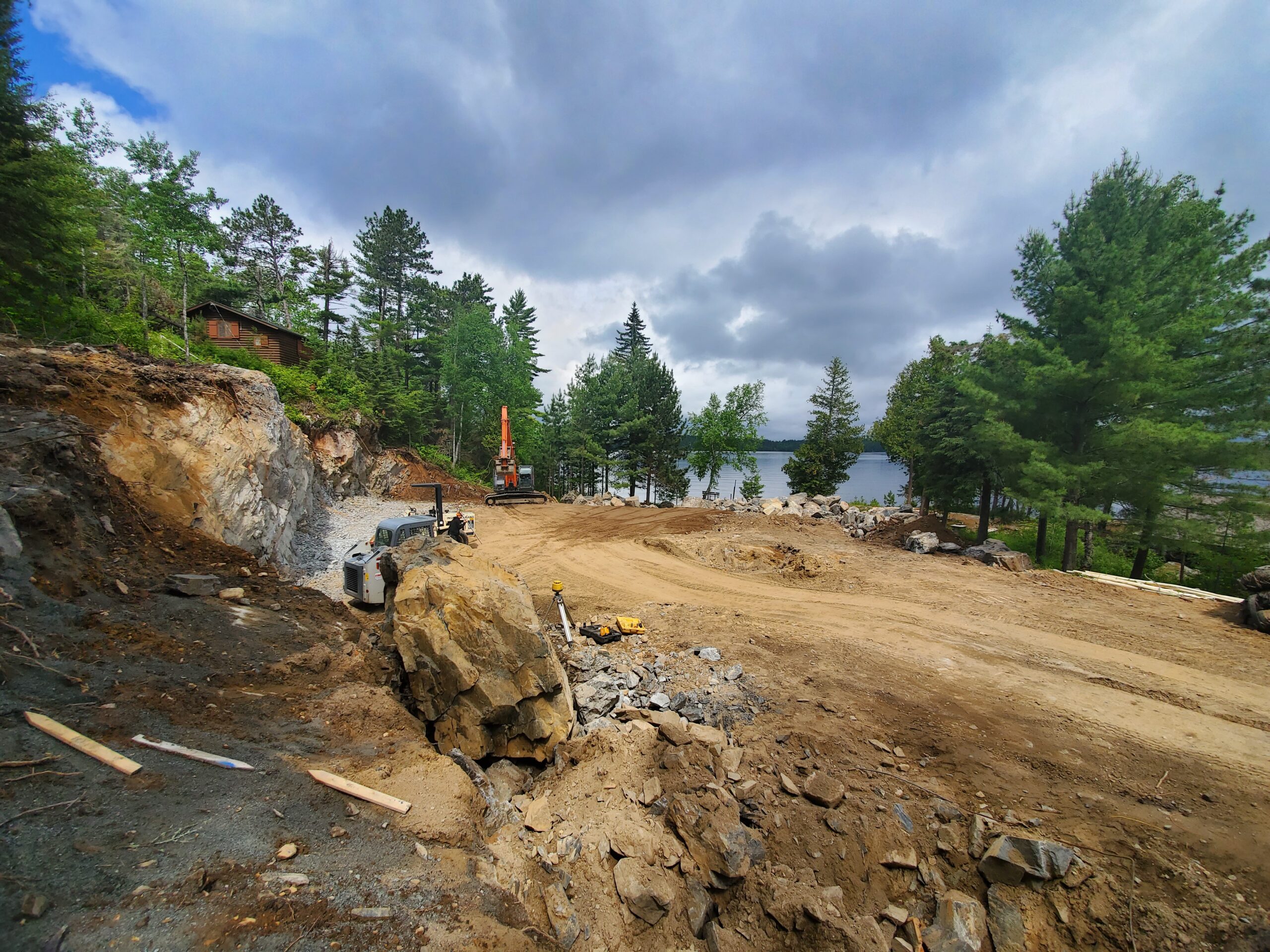 Blasting rock for new custom lake home by Huisman Concepts