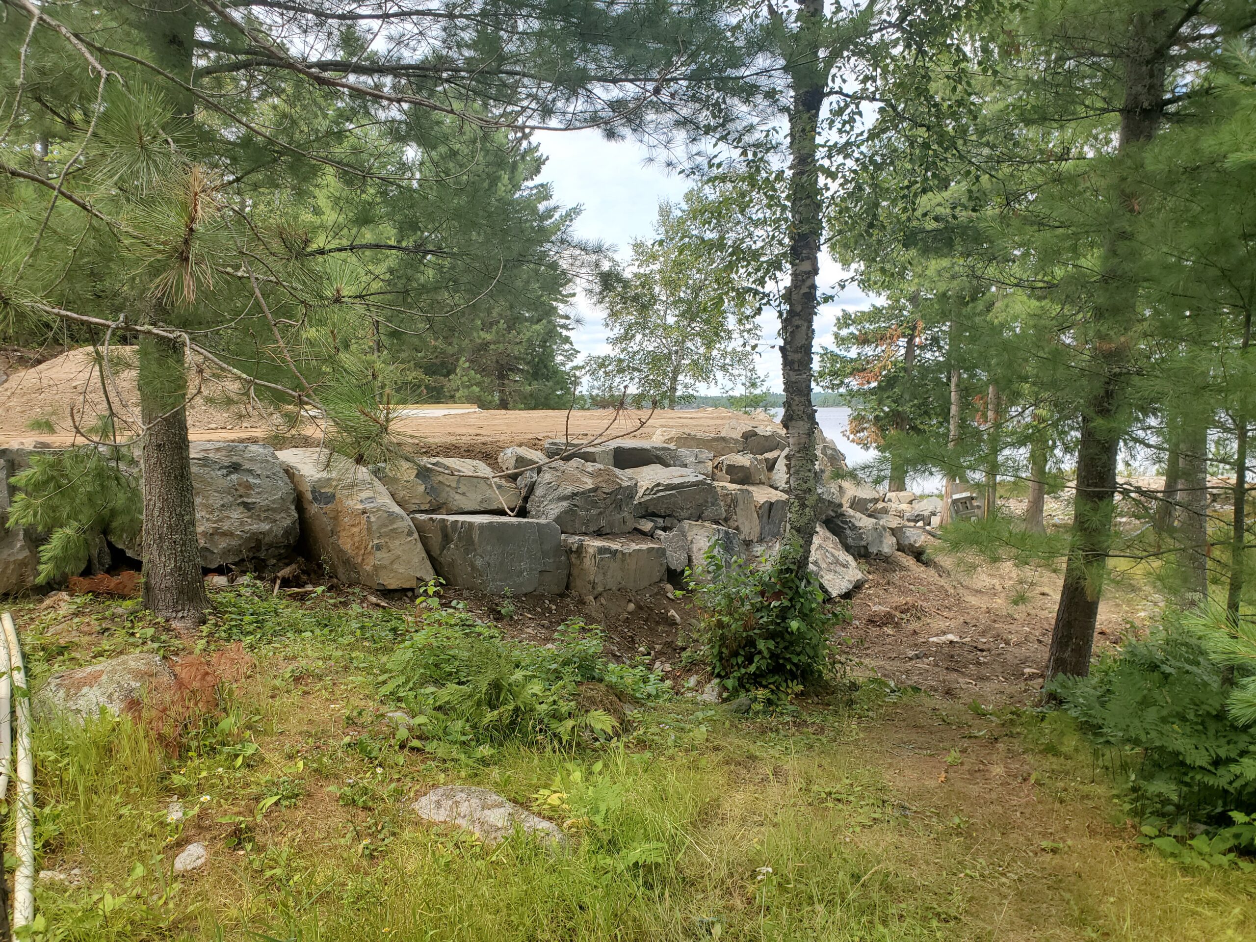 Retaining wall boulders, custom home by Huisman Concepts, Ely MN